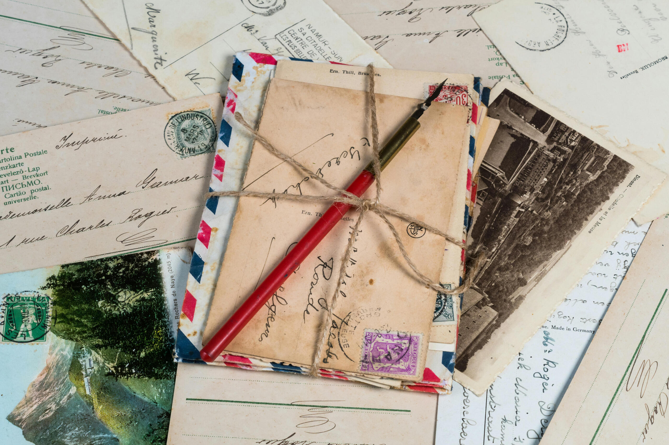bundle of postcards with fountain pen, wrapped in string